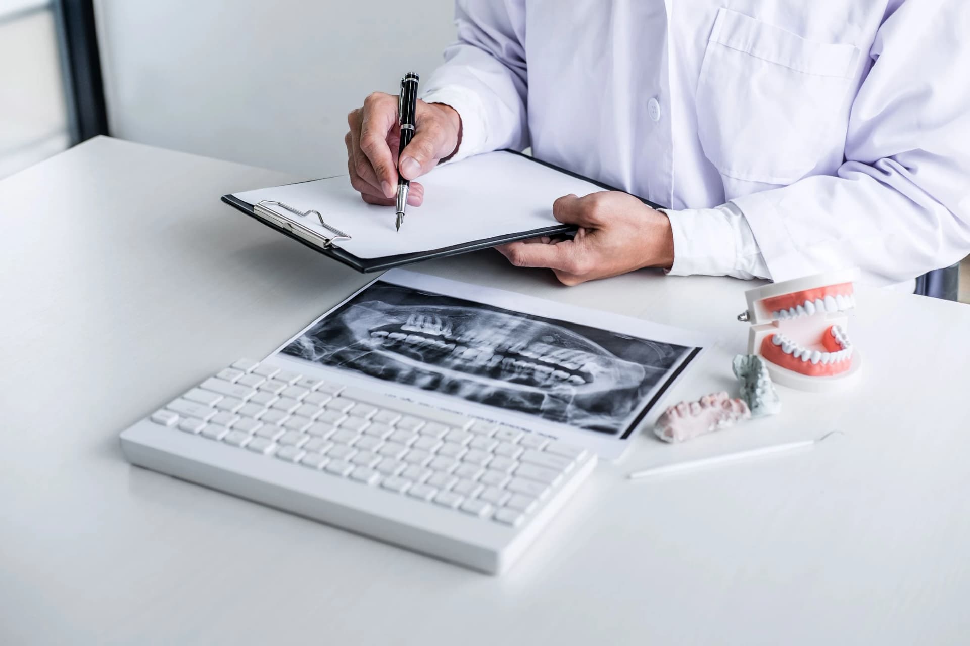 Dentist reviewing a patient's suitability for dental implants in Dubai